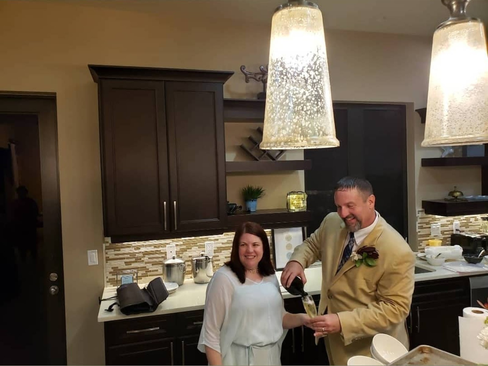 Couple toasting champagne in the kitchen