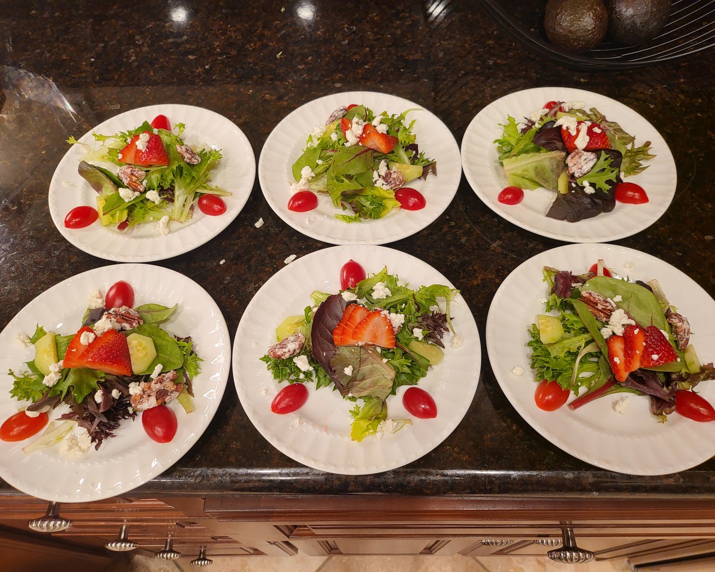 Strawberry salad with goat cheese, pecans, and tomato