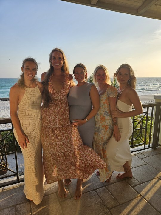 Friends on a balcony over the water