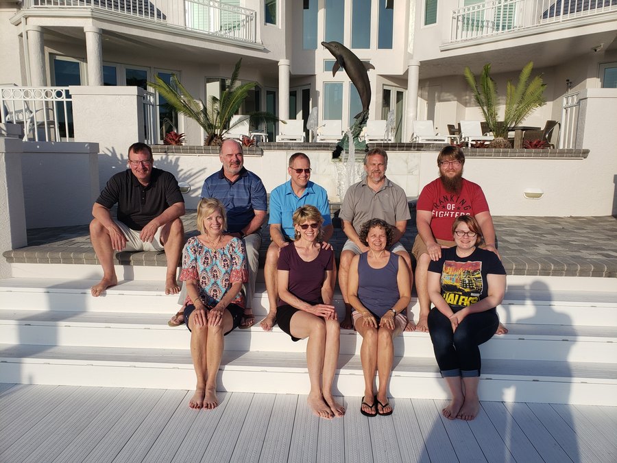 Guests on the steps of an island beach house