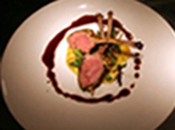 Seared duck breast plated with sauce