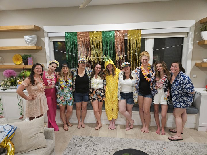 Party group in front of streamers