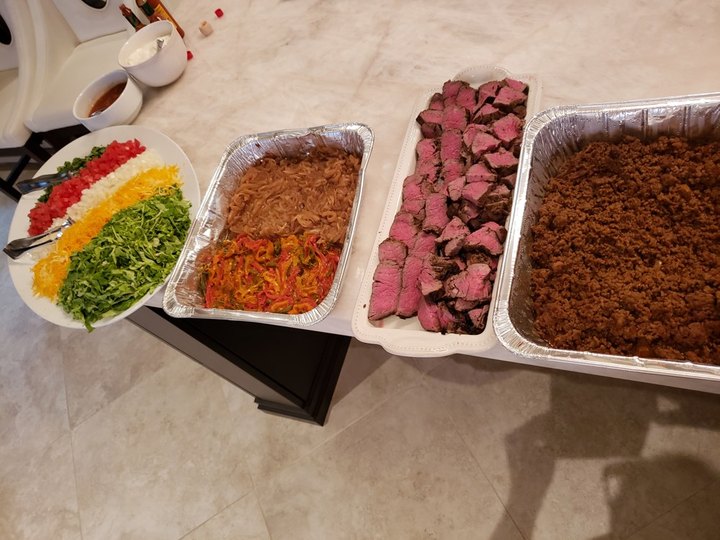 Taco bar trays with salsa and seasoned meats